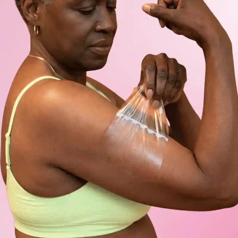 Shape Tapes lifting tape applied to a woman's upper arm